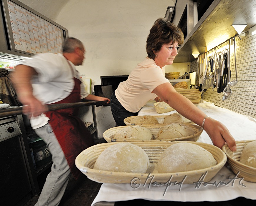 putting the bread into the oven for baking