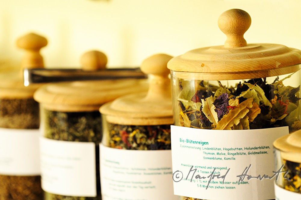 glass container with dried herbs at the tea self service station