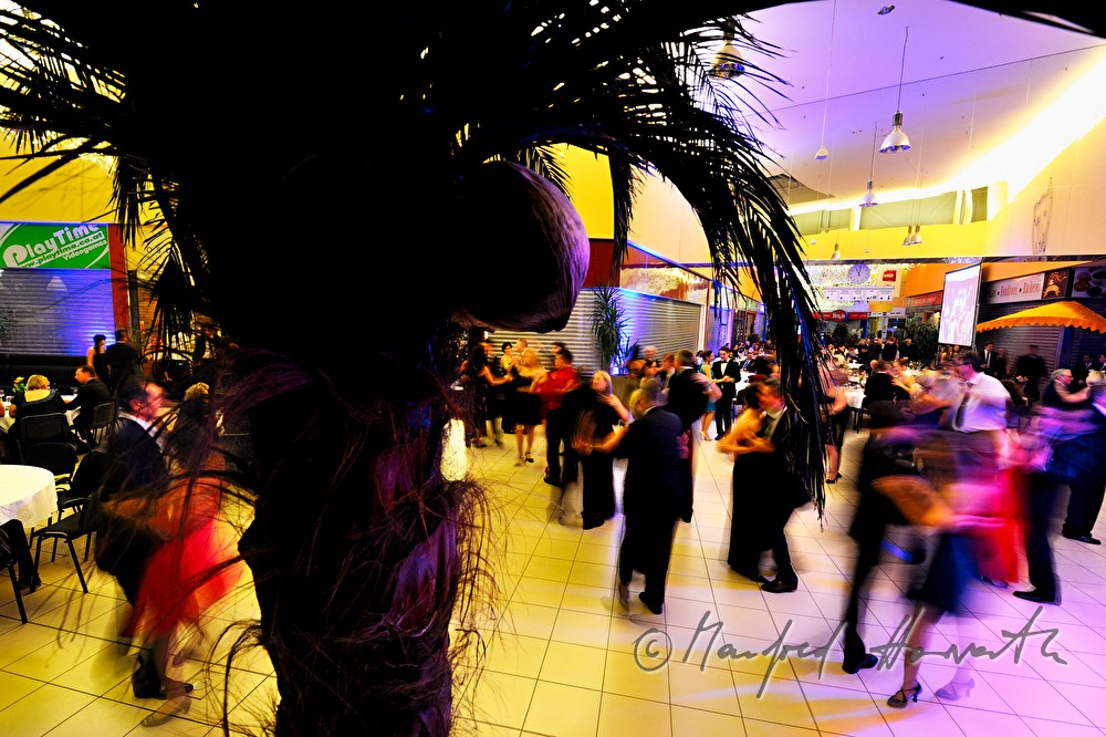 people dancing in front of closed shop windows