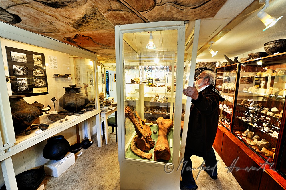 private archeologist opens the showcase in his collection