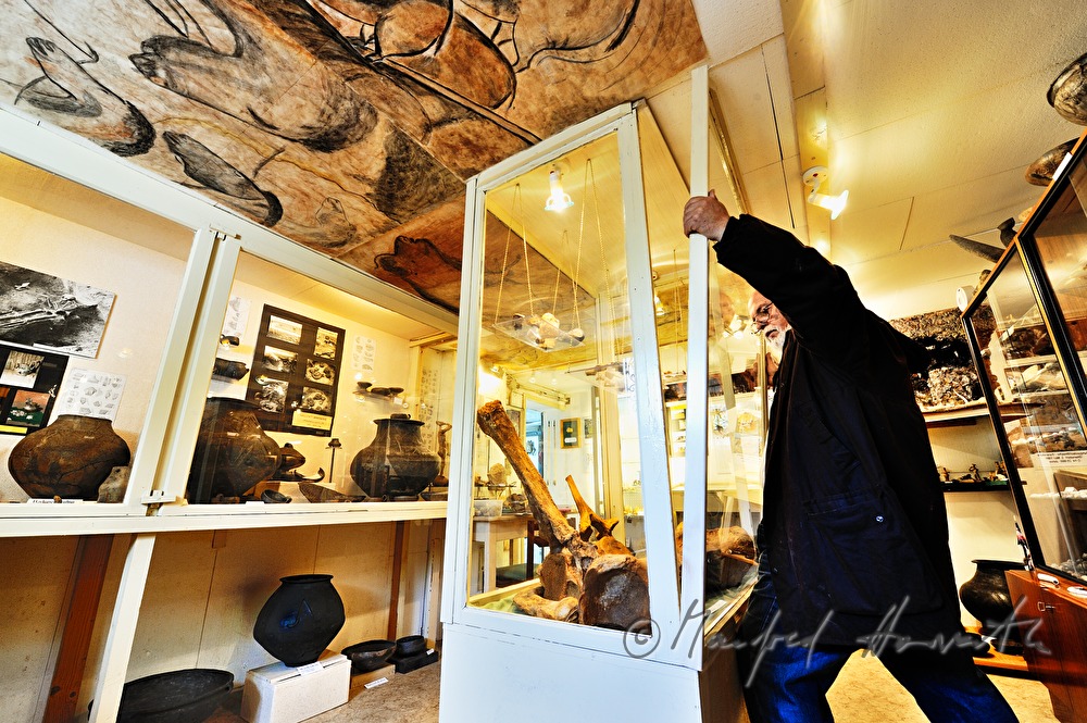 private archeologist opens the showcase in his collection