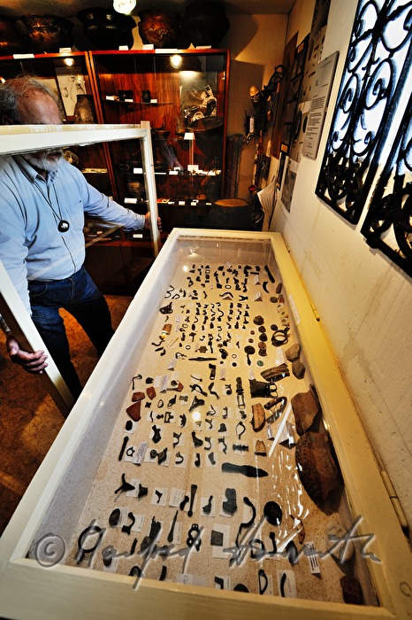 private archeologist opens the showcase in his collection