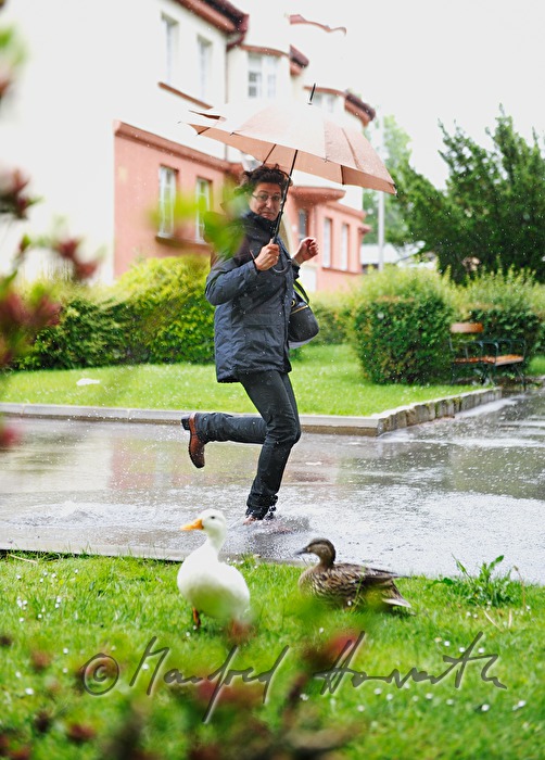 woman running with an umbrella in bad weather