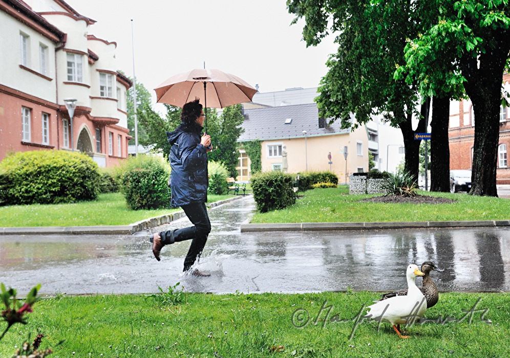 woman running with an umbrella in bad weather