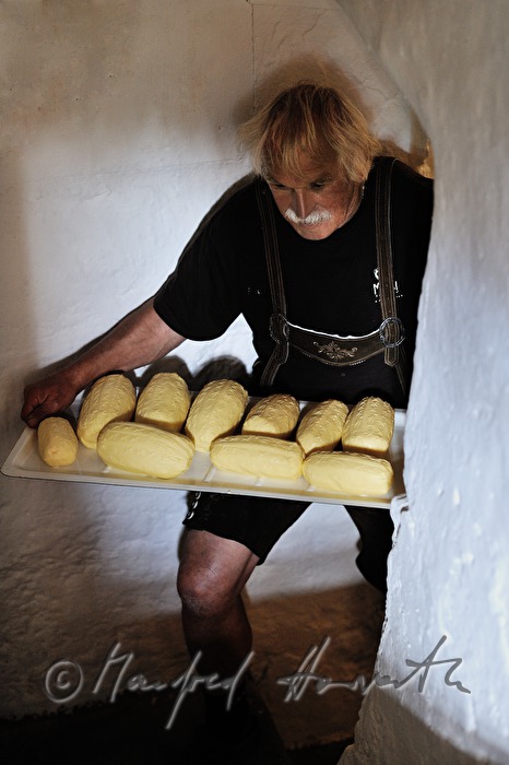 dairyman brings self made butter from the cellar