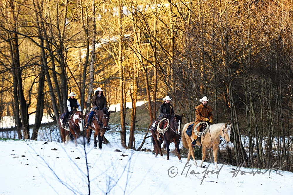 group of western riders near a stream