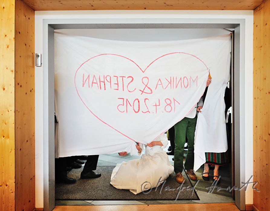 groom carries his new wife into the festivity hall