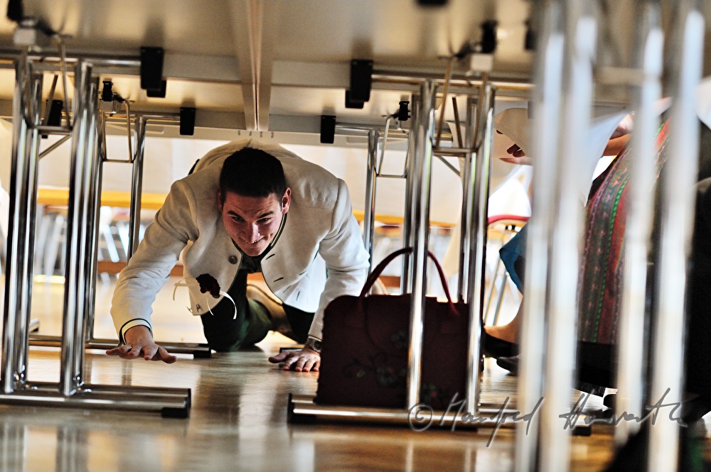 groom crawling under the table on the wedding party