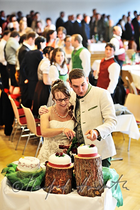 bridal couple cutting the wedding cake