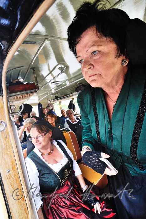 women in traditional clothes in a vintage autobus