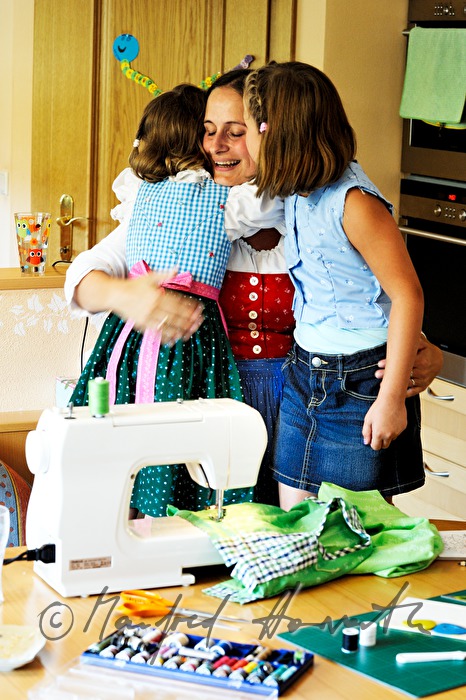 mother sewing a dress for her child