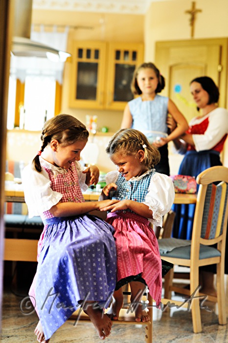 mother sewing a dress for her child