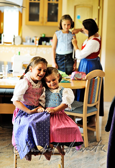 mother sewing a dress for her child