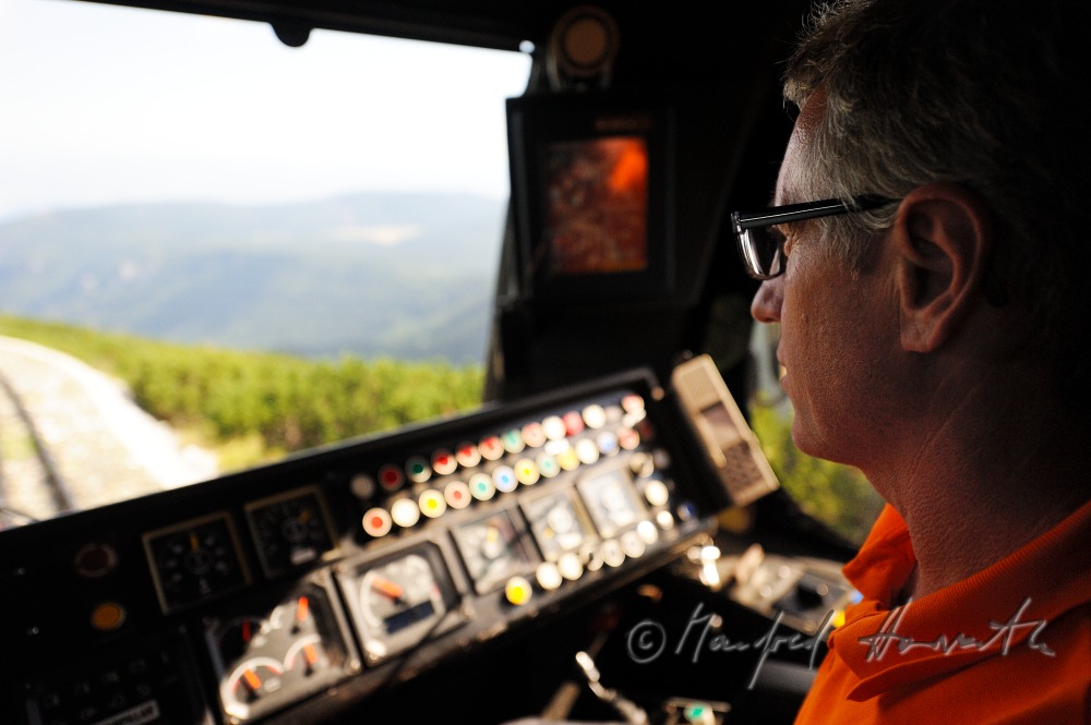 train driver of the cog railway in his cockpit