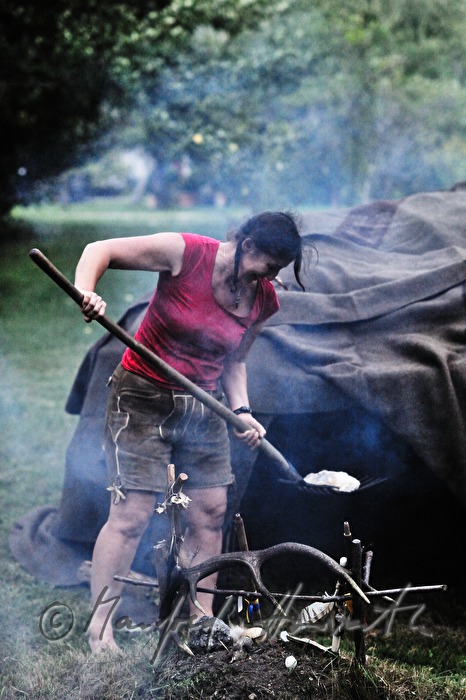 medicine woman brings hot stones from the fire