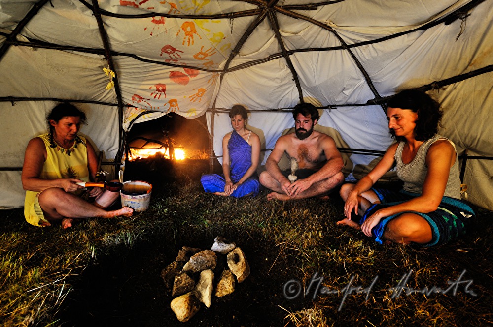 attendants of a shaman ritual pray and sing