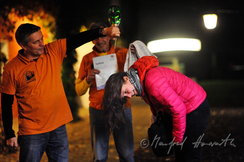 baptising of a passenger with champagne after the balloon ride