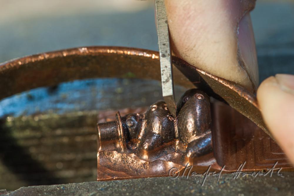 Erwin Perzy works on a snow man made of copper