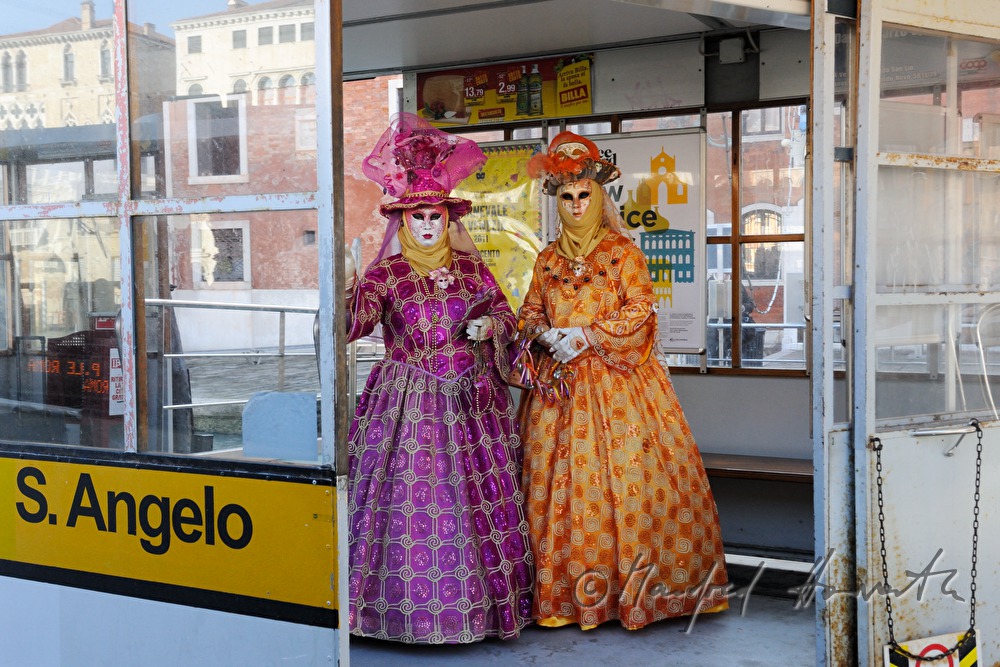 masked women waiting for the ferry boat