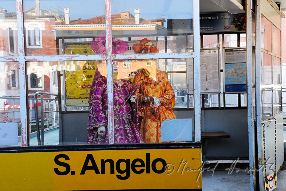 masked women waiting for the ferry boat