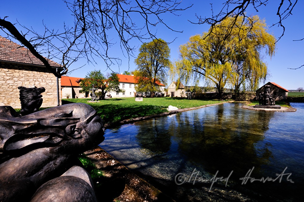 bronze sculpture and pond by the mill