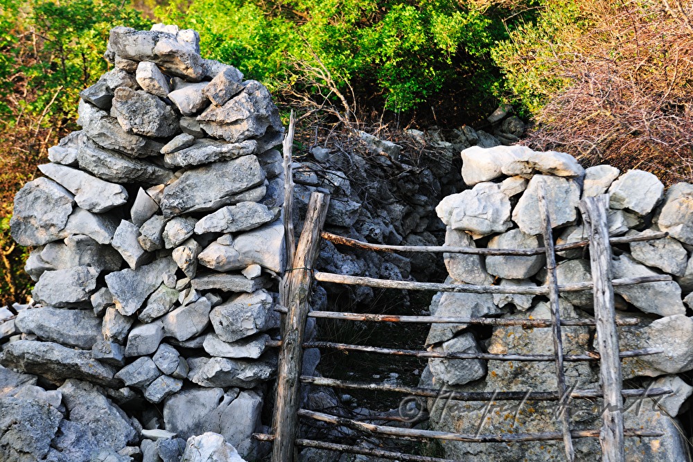 drystone wall and wooden fence