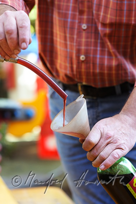 filling of bottles with cherry juice