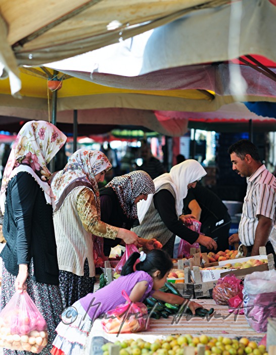 women shop at the weekly market