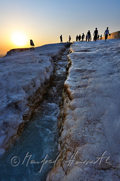 Calcareous sinter pool and tourists