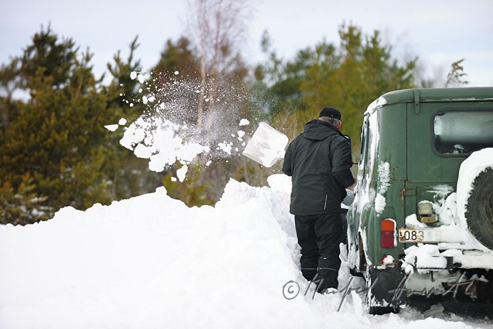 car driver shovels out his vehicle
