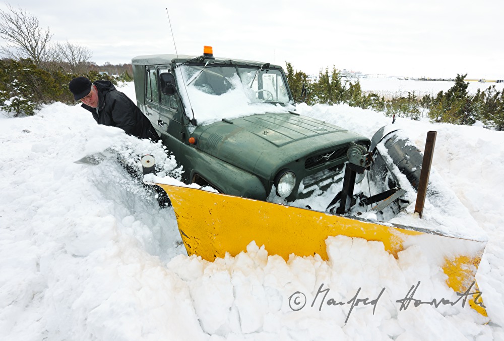 car driver shovels out his vehicle