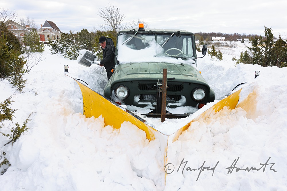 car driver shovels out his vehicle