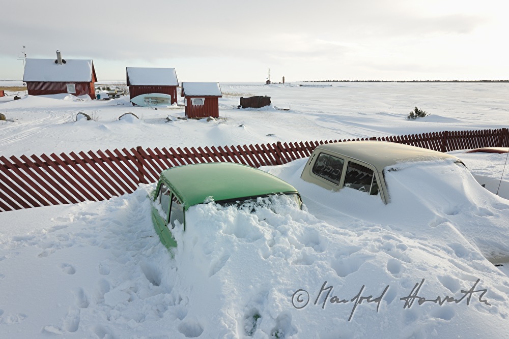snowed under car and boat houses