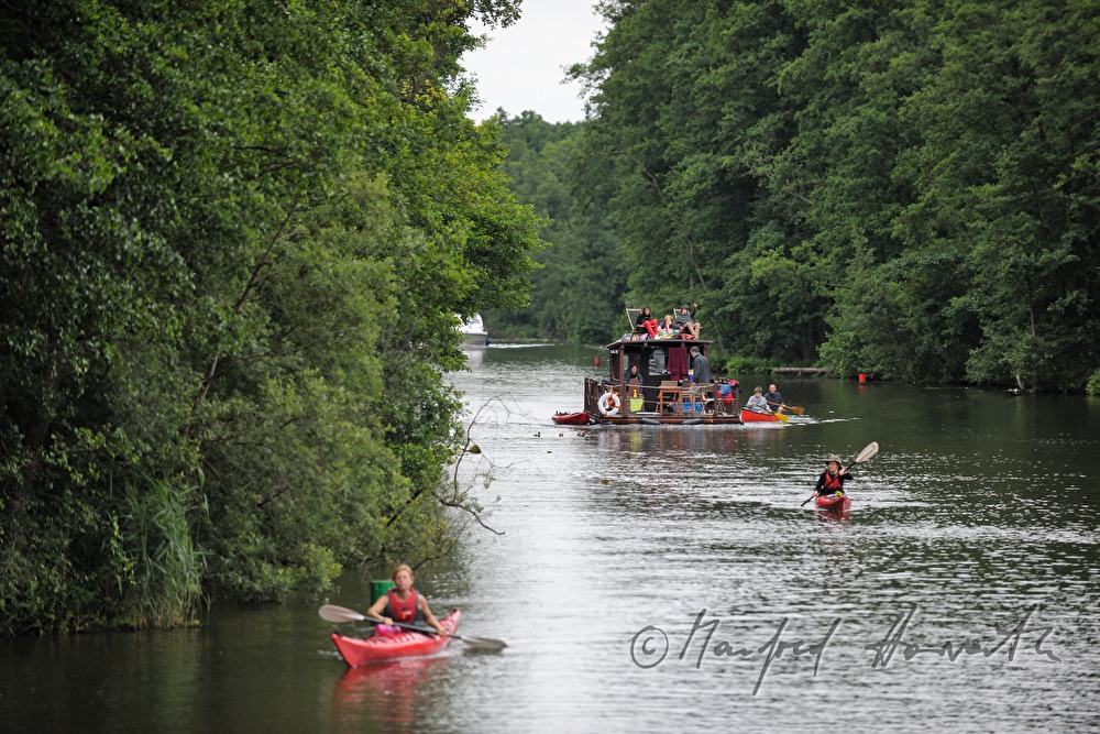 a group of kayakers float down the flood plains