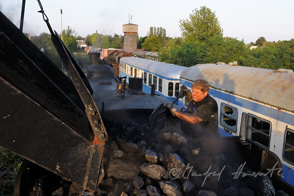 worker on the tender of a steam locomotive