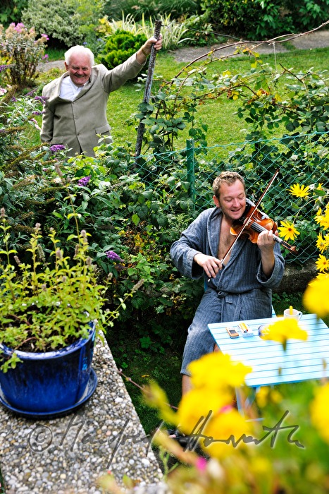 violinist Wolfgang Goellner plays in his garden