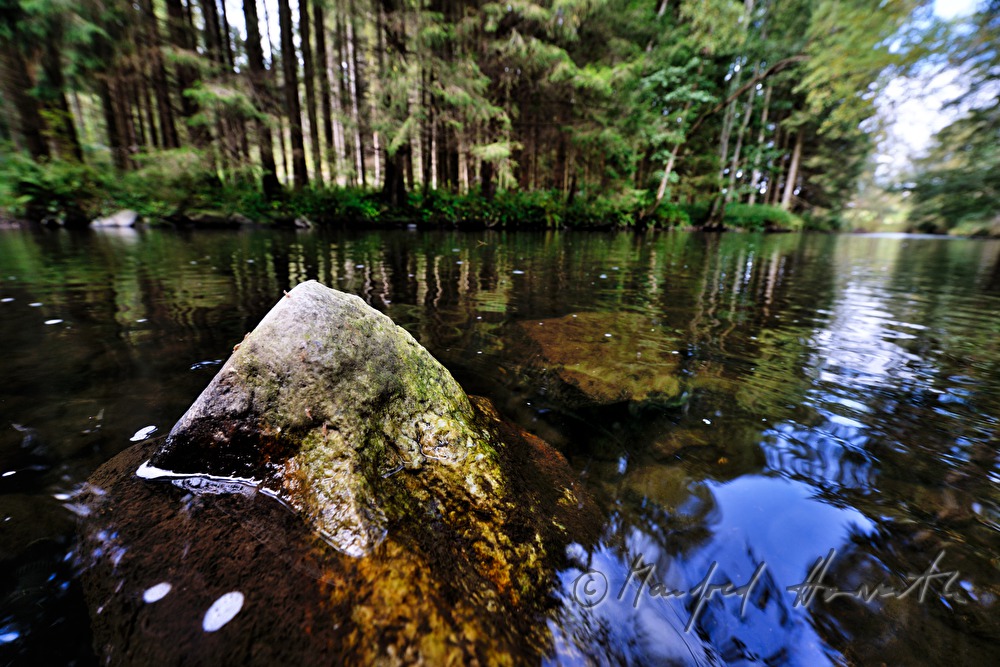 stone in the riverbed is washed by the water