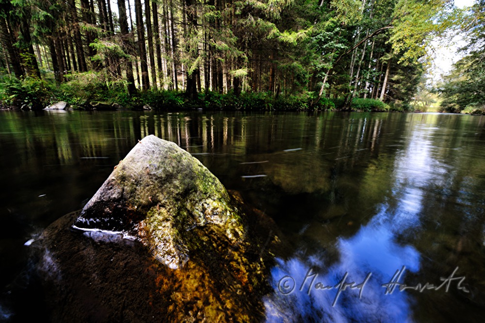stone in the riverbed is washed by the water