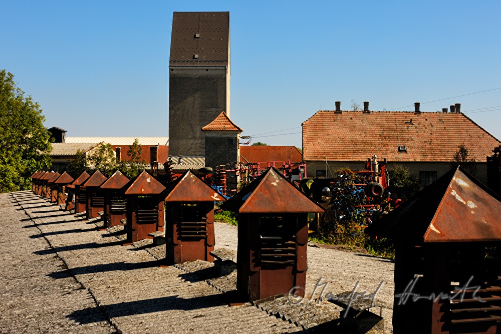 rusty ventilation hoods on the roof of a barn