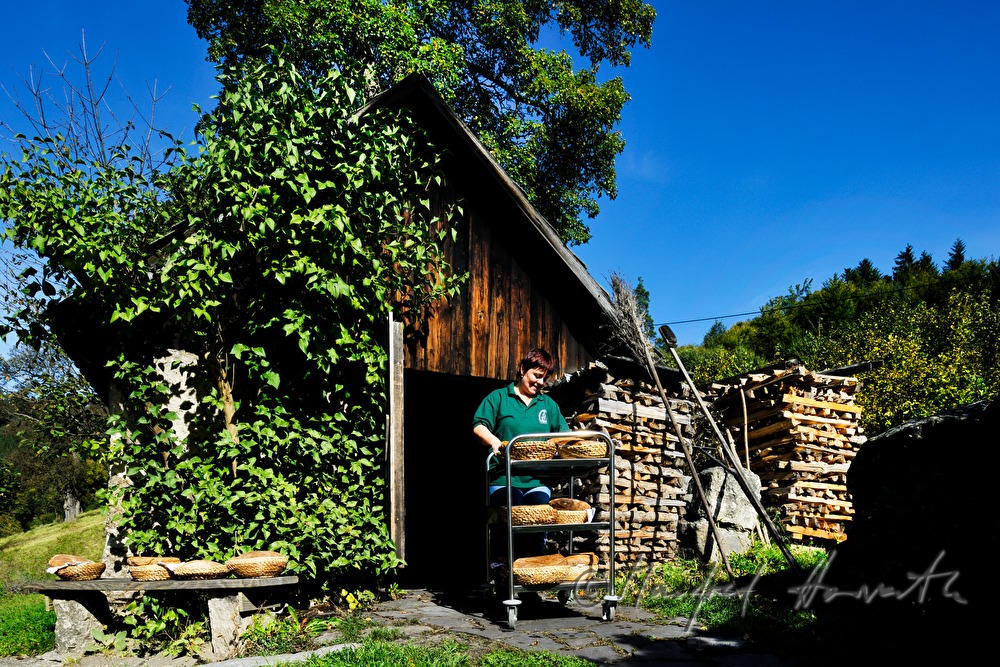 baking bread in the wood fired oven in the bakehouse