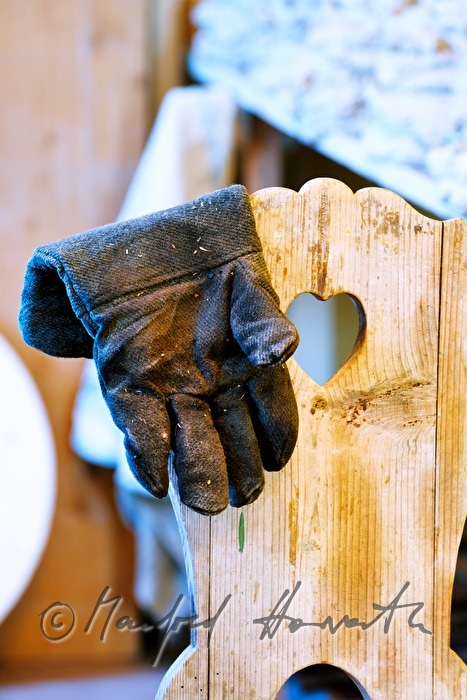 fireproof gloves on a chair in the workshop