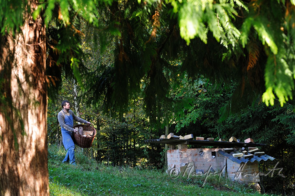 potter Joef Wieser carries wood to the kiln