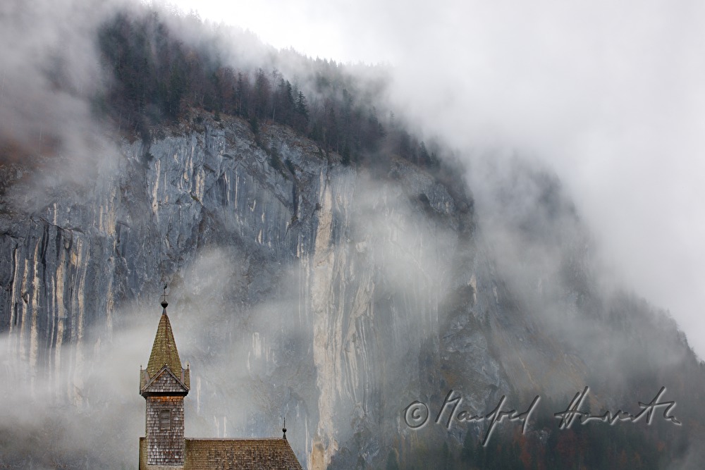 shingle made church of Gössl and fog in the mountains