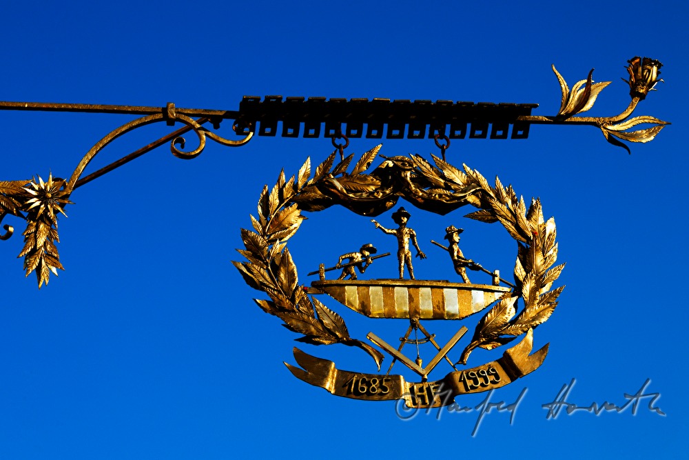 iron guild symbol on the fassade of the toll house