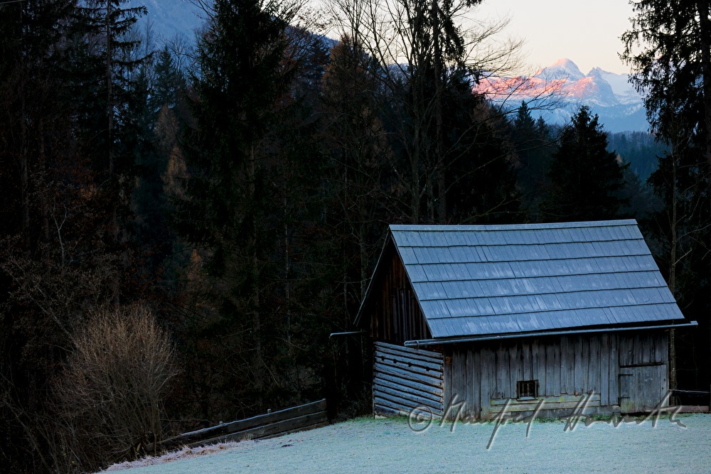  snowcovered barn and the peak of the Dachstein