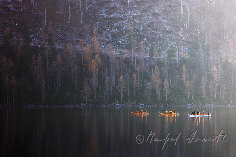 flat-bottomed boats in the backlight