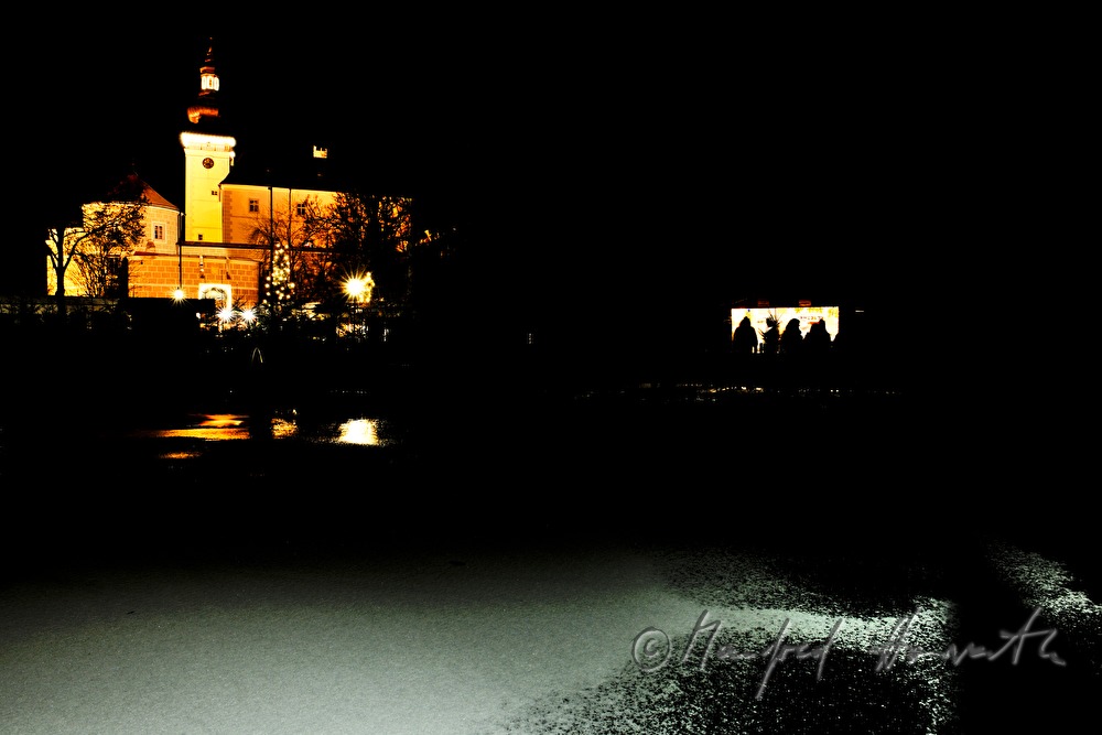 frozen pond and stand at the christmas market
