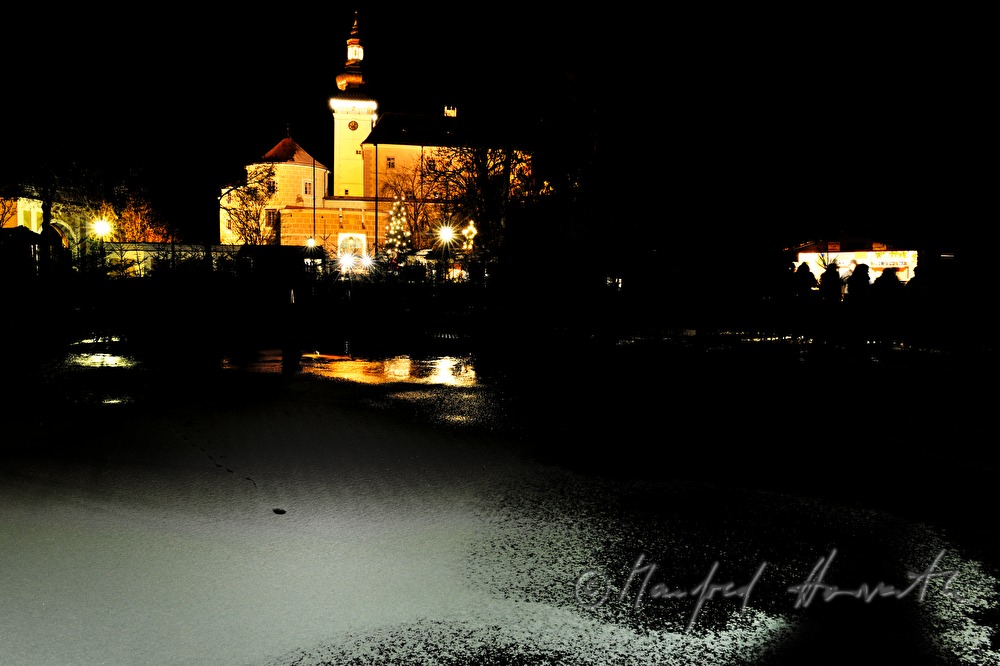 frozen pond and stand at the christmas market