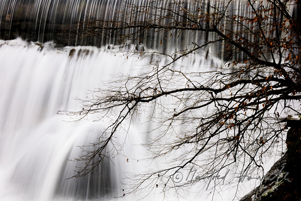waterfall and dam near an old water mill