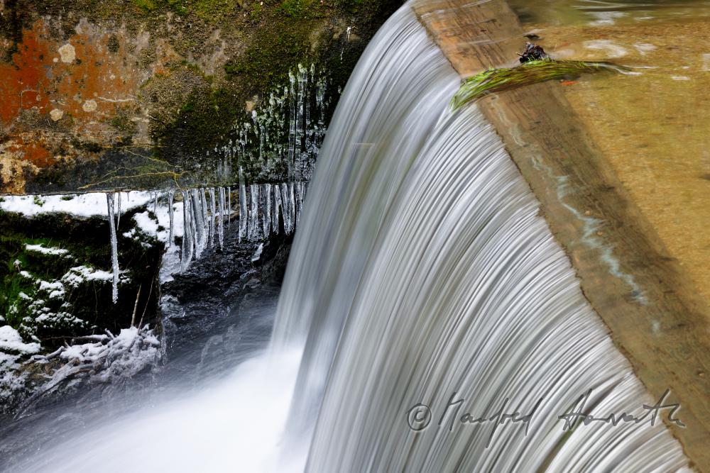 waterfall and dam near an old water mill